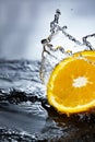 Orange fruit slice in water splash stream Royalty Free Stock Photo