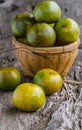 Orange fruits and basket on wooden background