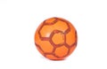 Orange futsal soccer ball with red hexagon stripes isolated on white background