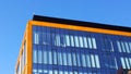 Orange and glass building exterior. Modern architecture. Skyscraper geometry. Business office park. Urban real estate. Economics a Royalty Free Stock Photo