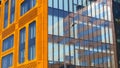 Orange and glass facade of building. Modern architecture background. Skyscraper geometry. Business office park. Urban real estate Royalty Free Stock Photo