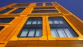 Orange and glass facade of building. Modern architecture. Skyscraper geometry. Business office park. Urban real estate. Royalty Free Stock Photo