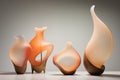Orange glass vases on a gray background. Wave-shaped vases Royalty Free Stock Photo