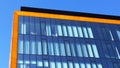 Orange and glass wall of corporate building. Modern architecture. Skyscraper geometry. Business office park. Urban real estate. Royalty Free Stock Photo