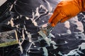 Orange glove, metal scraper, sponge and foam cleaner. Washing the cooktop. Selective Focus. The concept of home cleaning an Royalty Free Stock Photo