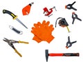 Orange gloves of a worker and a construction tool Royalty Free Stock Photo