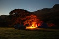 The orange glow of a brightly burning camp fire at night Royalty Free Stock Photo