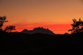 The orange glow of sunset creating a silhouette of the mountains of Torres del Paine National Park Royalty Free Stock Photo