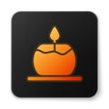 Orange glowing neon Aroma candle icon isolated on white background. Black square button. Vector