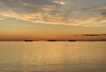 Orange  gold sunset cloudy  at sea water reflection ship on horizon nature landscape seascape Royalty Free Stock Photo