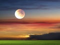 Full moon night sky ,gold sunset sunbeam ,dramatic fluffy clouds at evening sky  and green grass on field  nature lands Royalty Free Stock Photo