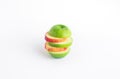 Orange and green apple slice mix on white color background. Royalty Free Stock Photo