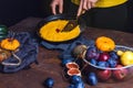 Orange and green pumpkins, walnuts, viburnum and pumpkin pie on a cloth