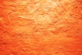 Orange grunge texture background. Painted wall. Bright saturated color. Rough surface plaster. Gradient. Royalty Free Stock Photo