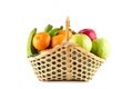 Orange, guava, banana and apple in wicker basket on white background fruit health food isolated Royalty Free Stock Photo