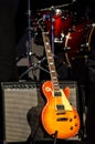 Orange guitar and amplifier into the light on stage. Music Instruments, Drums/Guitar on stage Royalty Free Stock Photo