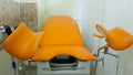 an orange gynecological chair in the medical office. Royalty Free Stock Photo