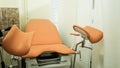 an orange gynecological chair in the medical office. Royalty Free Stock Photo