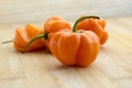 Orange habaneros on bamboo cutting board Royalty Free Stock Photo