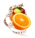 Orange half apple and measure tape Royalty Free Stock Photo