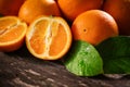 Orange, half of orange, orange lobule on the wooden table