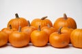Orange halloween pumpkins standing in line on white background