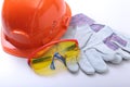 Orange hard hat, goggles and safety gloves on a white background. Royalty Free Stock Photo