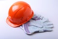 Orange hard hat, goggles and safety gloves on a white background. Royalty Free Stock Photo