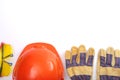 Orange hard hat, leather work gloves and safety glasses on a white background. Copy space. Royalty Free Stock Photo