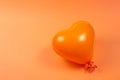 Orange heart ballon on orange background