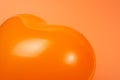 Orange heart ballon on orange background