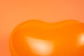 Orange heart ballon on orange background