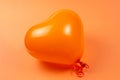 Orange heart ballon on orange background