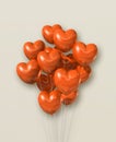 Orange heart shape air balloons group on a beige background