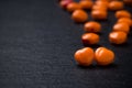 Orange heart shaped pills or candy on grunge black Royalty Free Stock Photo