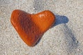 Orange heart shaped stone at the beach Royalty Free Stock Photo