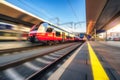 Orange high speed train in motion on the railway station Royalty Free Stock Photo