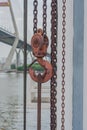 Orange hook hanging on a chain. Royalty Free Stock Photo