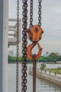 Orange hook hanging on a chain. Royalty Free Stock Photo