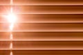 Orange horizontal blinds on the window create a rhythm through t