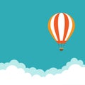 orange hot air balloon flying in the blue sky with clouds. Flat cartoon background. Royalty Free Stock Photo