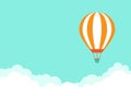 Orange hot air balloon flying in blue sky with clouds. Flat cartoon horizontal background Royalty Free Stock Photo