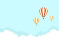 Orange hot air balloon flying in blue sky with clouds. Flat cartoon horizontal background Royalty Free Stock Photo