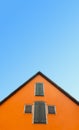 Orange house against blue sky. House with orange walls minimalist. German architecture Royalty Free Stock Photo