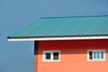 Orange house with blue roof blue sky backgroun Royalty Free Stock Photo