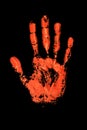 Orange human hand print on black background isolated close up, red handprint illustration, palm and fingers silhouette mark