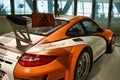 Orange hybrid Porsche on display in museum