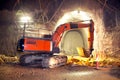 Orange Hydraulic Excavator in Concrete Tunnel Construction