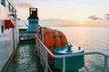 Orange inflatable lifeboats on ferry deck for emergencies and maritime accidents. Rescue boat, raft on the roof of a ferry.  Life Royalty Free Stock Photo