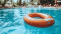 Orange inflatable ring floating in a turquoise swimming pool on Royalty Free Stock Photo